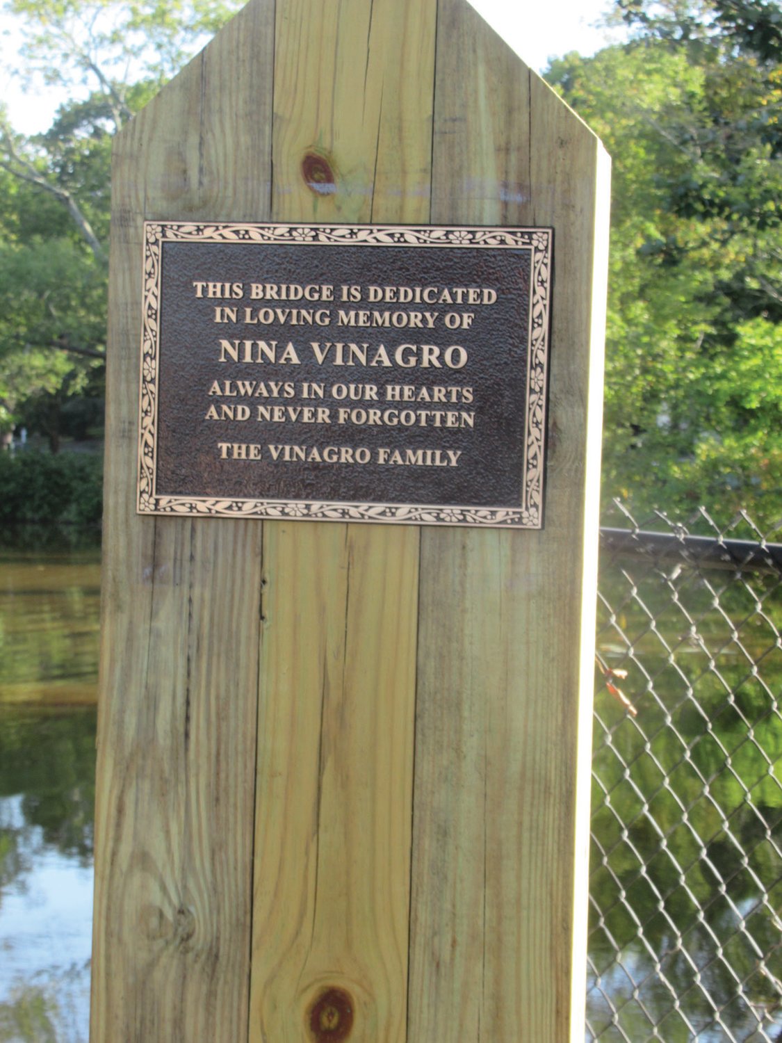 MIGHTY MESSAGE: This is the bronze plaque that was unveiled Saturday morning in honor of the late Nina Vinagro, for whom the new footbridge inside War Memorial Park is named.
